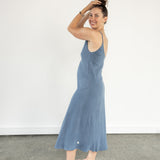 Side profile of Ribbed Aisling organic cotton dress, showing elegant fit and built-in shelf lining. Indigo