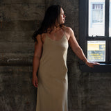 Front view of model wearing Aisling organic cotton long dress, showcasing soft flowy silhouette. Pomegranate