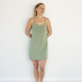 Front view of model wearing Aisling organic cotton short ribbed dress, highlighting soft ribbed texture and built-in shelf. Mulberry Green