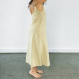 Side profile of Aisling organic cotton dress, showing elegant fit and built-in shelf lining. Pomegranate
