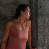 Front view of model wearing Aisling organic rib cotton long dress, showcasing fit around shoulders and breasts. Naturally dyed in Rubia for sensitive skin