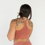 Back view of Branna organic cotton bralette, featuring razorback design and smooth finish. Naturally dyed for sensitive skin. Rubia