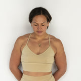 Front view of model wearing Branna organic cotton razorback bra, showing soft, supportive fit. Naturally dyed with Pomegranate skins