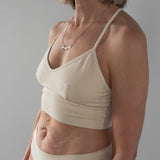 Front view of model wearing Branna organic cotton razorback bra, showing soft, supportive fit. Beautiful Cream for extra sensitive skin