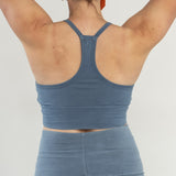 Back view of Branna organic cotton bralette, featuring razorback design and wider straps. Naturally dyed in Indigo