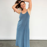 Front view of model wearing Aisling organic cotton long dress, showcasing soft flowy silhouette. Indigo