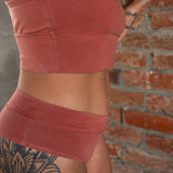 ide profile of model wearing Meara, showing mid-rise cut and smooth side finish in breathable organic cotton. in Rubia - close up