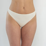 Front View:
Model wearing the Skye Organic Cotton G-String in ribbed finish, showcasing minimal coverage and soft, natural fit at the front. Ethically made and gentle on sensitive skin.