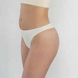 Side profile of model in Skye Organic Cotton G-String in rib, highlighting smooth lines, soft organic cotton fabric, and comfortable fit designed for freedom and breathability.