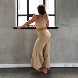 Back view of Danu organic cotton flare pants showing wide-leg cut and natural drape. Nayurally dyed with Pomegranate skins