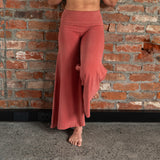 Front view of model wearing Danu organic cotton wide-leg flare pants, highlighting flattering seams and adjustable waistband. Naturally dyed with Rubia for sensitive skin