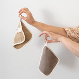 Little Brin walnut and pomegranate, naturally dyed organic cotton flannel hanging by its fabric loop, showcasing minimalist design and soft texture. Sustainable and friendly for sensitive skin