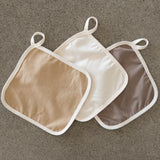 3 Little Brin single-layer organic cotton flannel laid flat, showing its lightweight cream and naturally dyed pomegranate and walnut fabric and simple finish. Sustainable and suitable for sensitive skin