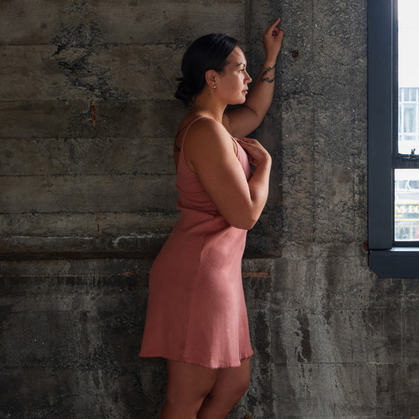 Side profile of Aisling organic cotton short dress, showing elegant fit an drape . Naturally dyed with Rubia root for sensitive skin