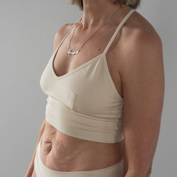 Front view of model wearing Branna organic cotton razorback bra, showing soft, supportive fit. Beautiful Cream for extra sensitive skin